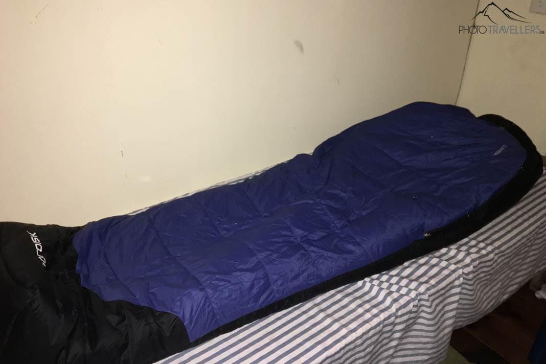 Un sac de couchage bleu sur un lit dans une lodge au Népal