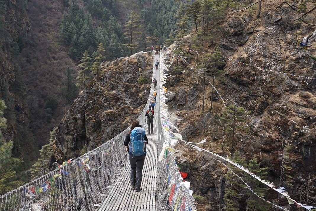 Blogueuse de voyage Biggi Bauer et d'autres randonneurs sur le pont Edmund-Hillary au Népal
