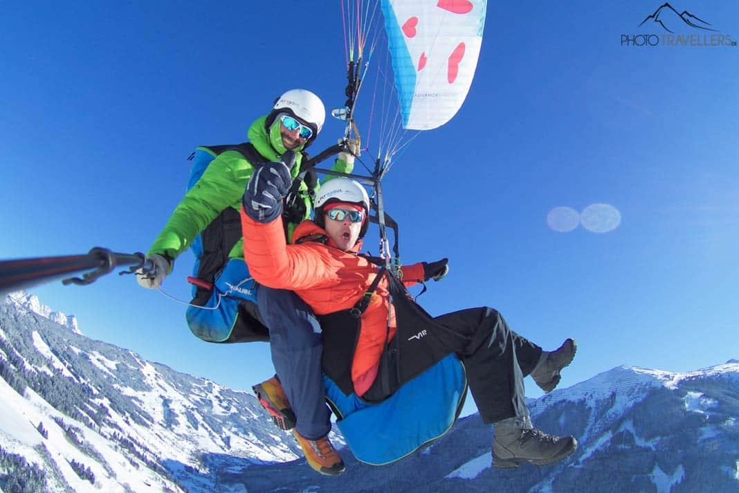 Blogueur de voyage Florian Westermann lors d'un vol en parapente dans les Alpes en hiver