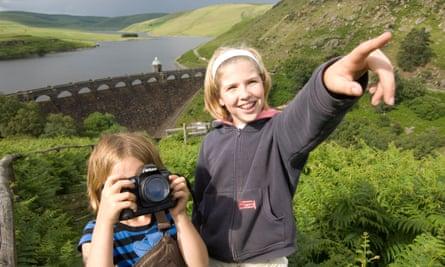 two young girls photographing at Graig Goch resevoir and dam