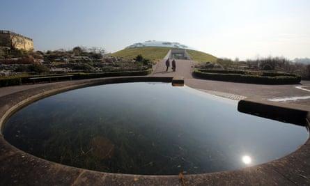 A couple by the lake in front of the Norman Foster designed Great Glasshouse at the National Botanic Garden of Wales