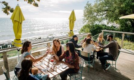 Diners on the waterside restaurant at the Drake Devonshire Hotel, Prince Edward County, Ontario, Canada.