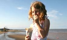 Girl eating fish and chips at Cleethorpes beach, Lincolnshire