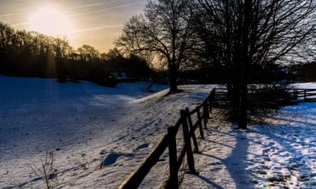The dawn sun rises over a snow covered Nettleton Bottom