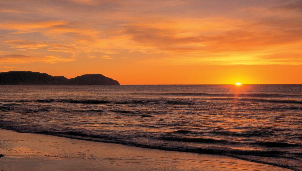 Wainui Beach: Swimming at sunrise.